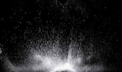 Explosion of white powder on a black background, isolated