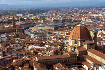 Aerial view of Florence, Italy on a sunny day with beautiful red rooftops of ancient houses and...