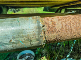 old, rusty pipe in a car for exhaust gases. exhaust port. road parts. junk, spare parts unsuitable...