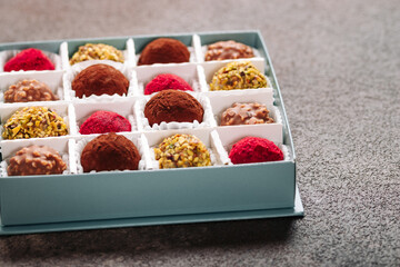 A set of truffle sweets with different fillings on a brown background