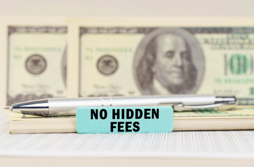 On the dollars are a pen and a sign with the inscription - No hidden fees