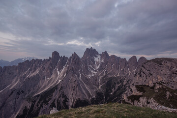 Mountains Panorama of the Dolomites at Sunrise with clouds. Photograph is showing Tre Cime di Lavaredo in the Dolomites, Italy. Beautiful morning, just before the sunrise with soft tones and colors.
