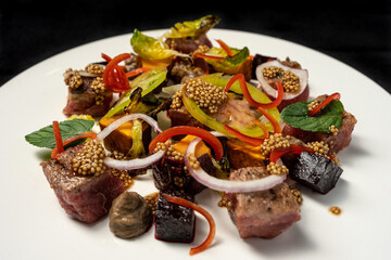 grilled beef cut into cubes with quinoa sauce with slices of green tomato, onion, basil, beets and sweet potato