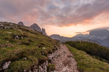 Fototapeta na wymiar Mountains Panorama of the Dolomites at Sunrise with clouds. Photograph is showing Tre Cime di Lavaredo in the Dolomites, Italy. Beautiful morning, just before the sunrise with soft tones and colors.