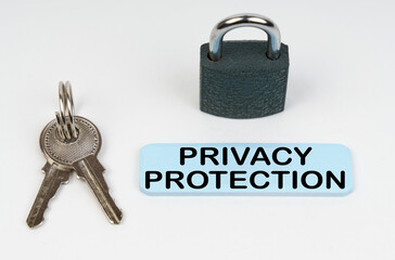 On a white surface there is a lock, keys and a blue sign with the inscription - Privacy protection