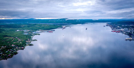 Panoramic aerial view of the port of Murmansk, ships and ship docks. Summer landscape in the north of Russia. Kola Bay of the Barents Sea