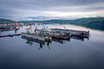 Fototapeta na wymiar Panoramic aerial view of the port of Murmansk, ships and ship docks. Summer landscape in the north of Russia. Kola Bay of the Barents Sea