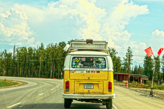 06-23-2002 Alaska USA - Yellow van that has been from Costarica to Alaska with flags and stickers of all countries its been through on back