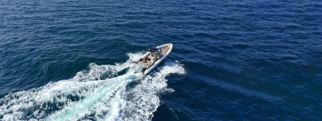 Aerial drone photo of  luxury inflatable rib speed boat cruising in mediterranean deep blue sea