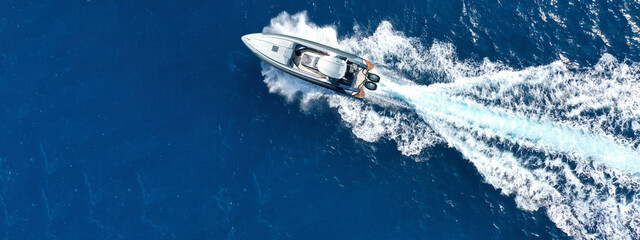 Aerial drone ultra wide photo with copy space of luxury rigid inflatable speed boat cruising in high speed in Aegean deep blue sea, Greece - obrazy, fototapety, plakaty