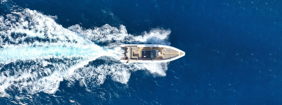 Aerial drone photo of  luxury inflatable rib speed boat cruising in mediterranean deep blue sea