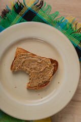 Bitten sliced bread with peanut butter 