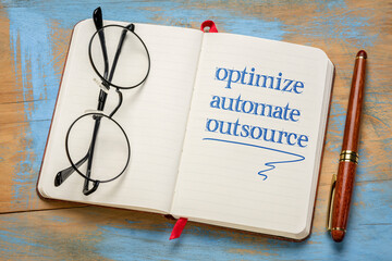 optimize, automate, outsource - business concept, handwriting in a notebook