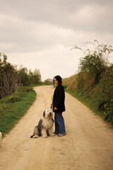 person walking  with her dog