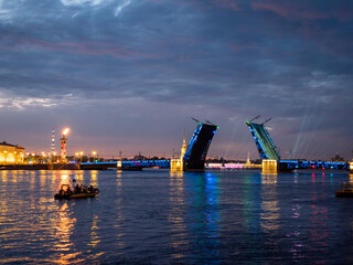 Fototapeta na wymiar Russia, Saint-Petersburg, Palace Bridge, night illumination, traffic, sail boats, reflection on water, rostral columns