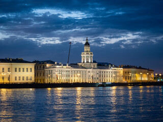 Saint-Petersburg, Russia. The building of the Kunstkamera with night illumination. Neva River. Reflection in water.