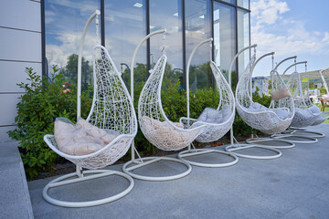 Garden hanging chairs on sale in the shop outside