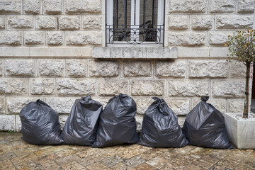 Plastic trash bags at the facade of the building