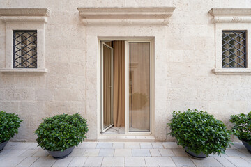 Fototapeta na wymiar Elegant glass door in beige color on the facade of a luxury building