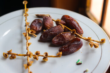 Close-up view of ripe date palm fruit on white plate is ready to eat