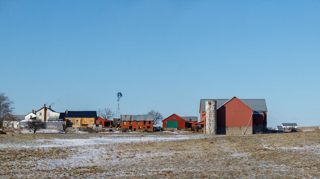 Amish farmstead in late winter among snowy fields under a clear blue sky | Amish country, Ohio