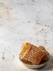 Honey in honeycombs in a saucer , text space