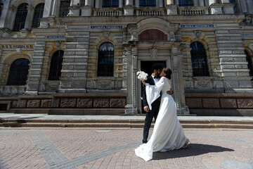 International couple kissing. Indian groom. Street wedding photo shooting.