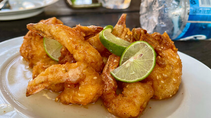 Batter fried sesame prawns with lime