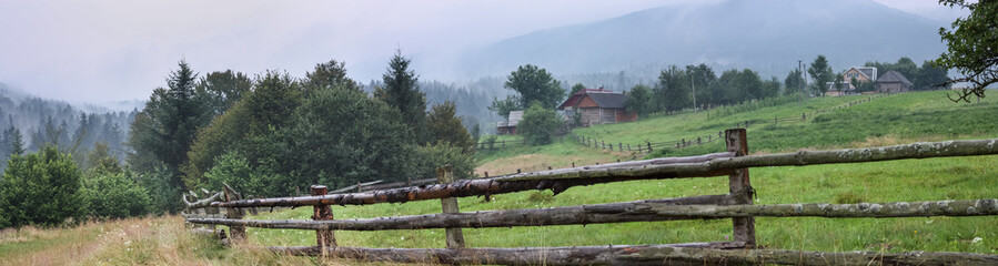 Rural landscape, panorama, banner, with a wooden fence for cattle, the Ukrainian Carpathians.