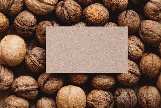 Plenty walnuts with shells with business card templete on it. Mock up.