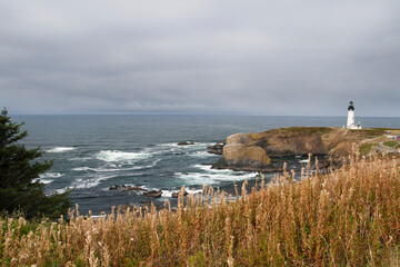 Dramatic landscape of the Pacific ocean seashore with lighthouse