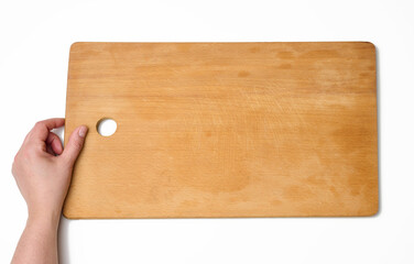 hand holds empty rectangular wooden cutting kitchen board on white background, top view