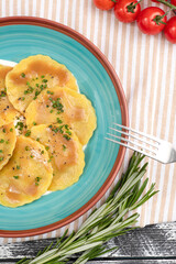 ravioli, italian ravioli on a white wooden background, top view