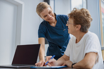 Female patient signing treatment agreement in doctor's office in clinic. High quality photo