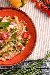 Pasta with salmon, pasta with fish on a white wooden background, top view