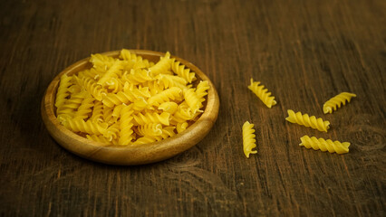 pasta in a dish dry appetizing spiral macaroni in the kitchen food preparation