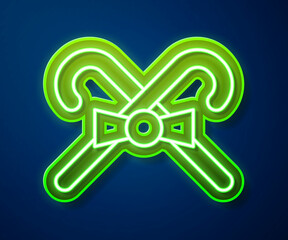 Glowing neon line Christmas candy cane with stripes icon isolated on blue background. Merry Christmas and Happy New Year. Vector