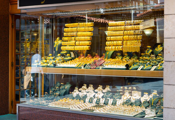 Display window of jewelry shop in Konya, Turkey. Abundance of gold chains, necklaces and bracelets.