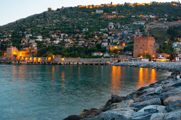 Red Tower and Tersane shipyard in twilight. Alanya, Antalya Province, southern coast of Turkey.