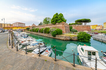 Boats line the crowded canals of the Venezia Nuova area next to the New Fortress at the seafront...