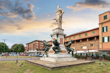 The historic statue, Monument of the Four Moors which depicts the duke Ferdinand I with four Moorish slaves as reminder of Livorno's slave market, at the Livorno, Italy port at early evening. - obrazy, fototapety, plakaty