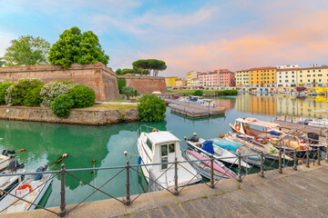 Boats line the crowded canals next to the New Fortress at the seafront Tuscan city of Livorno,...