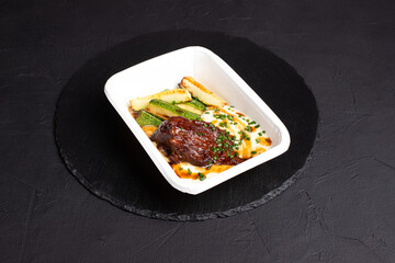 Beef cheek, beef cheek on a black background, side view