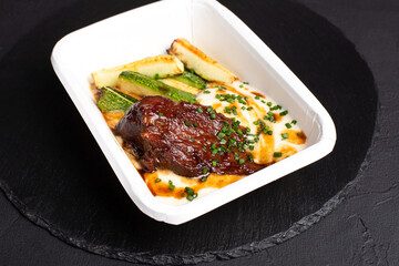 Beef cheek, beef cheek on a black background, side view