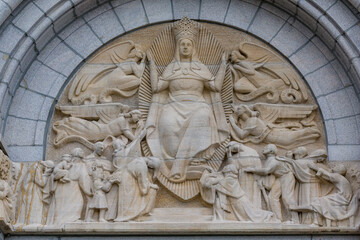 Beautiful sculpture at the entrance of Basilica of Sainte-Anne-de-Beaupre, Cathedral, Quebec an important Catholic sanctuary, which receives about a half-million pilgrims each year. 