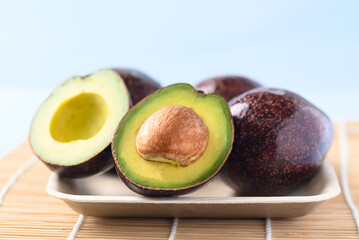 Ripe avocado fruit on plate ready to eating, Tropical fruit