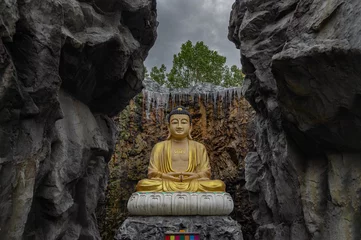 Tuinposter Big golden buddha statue in the middle of a beautiful cavein, Luang Pho Toh Mahayana at Wat Laksee ratsamosorn, Ban Phaeo district. © num