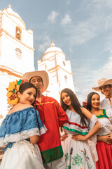 Teenagers from Nicaragua with traditional Latin American clothing with the cathedral church of...