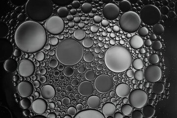 abstract background with oil bubbles on grey gradient colour.