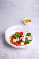 Tomato slices with cheese balls and spicy oil